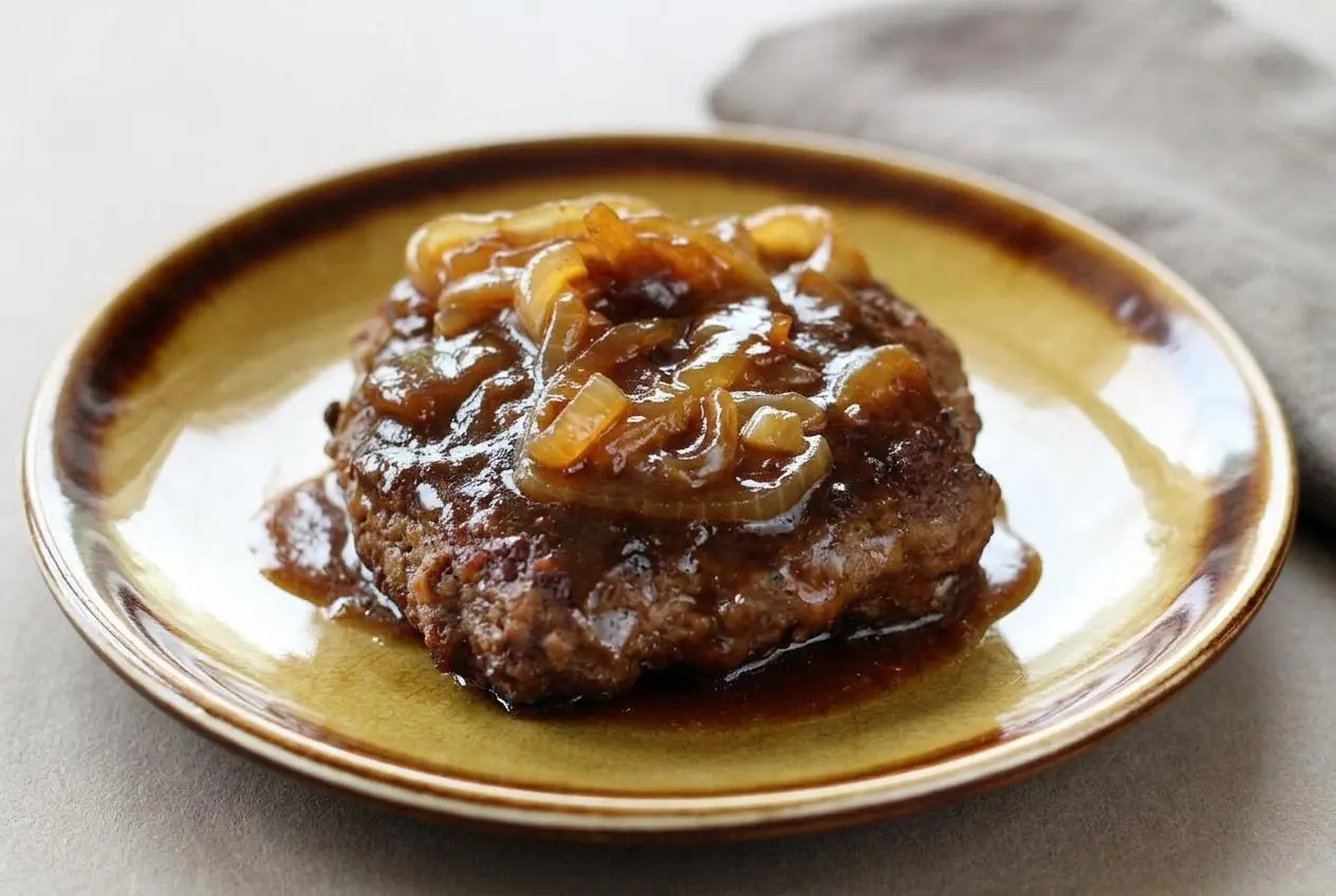 Tender skillet hamburger steaks smothered in savory brown onion gravy with a caramelized crust.