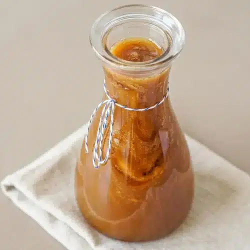 Toasted marshmallow syrup with a luminous amber color and smooth glossy pour for homemade coffee drinks.