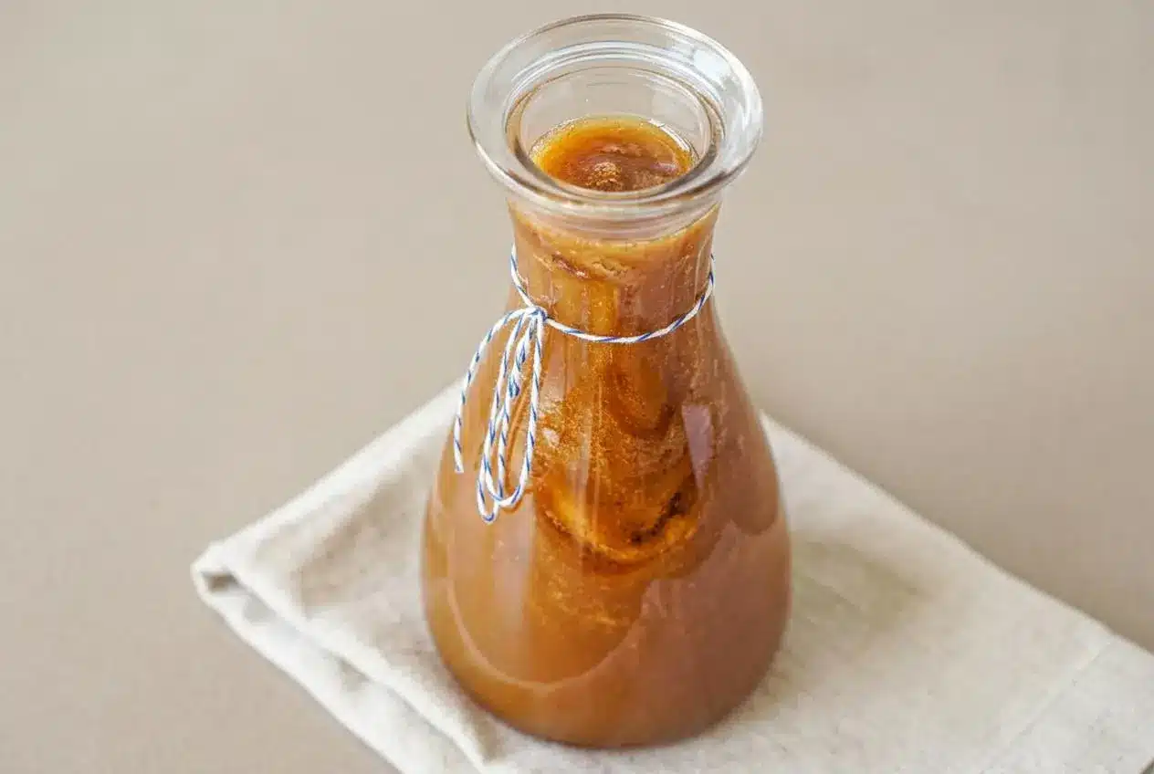 Toasted marshmallow syrup with a luminous amber color and smooth glossy pour for homemade coffee drinks.