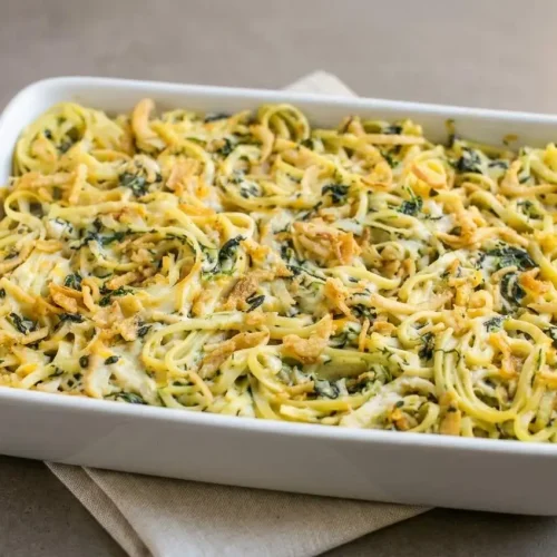 Creamy Monterey chicken spaghetti casserole with tender chicken, spinach, and a crispy golden fried onion topping.