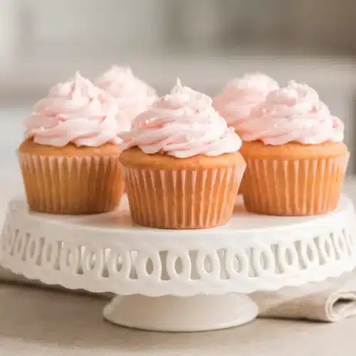Tender pink Champagne Cupcakes topped with swirls of silky sparkling wine buttercream.