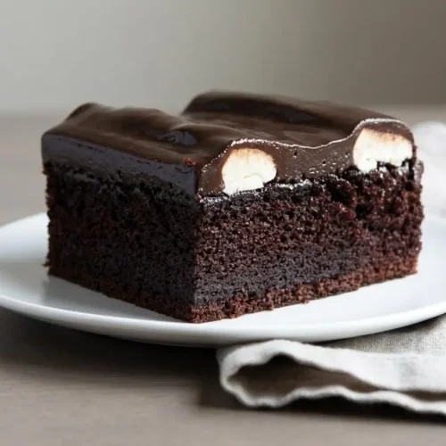 Finished bumpy cake recipe in a 9x13 pan with moist chocolate cake, white buttercream ridges, and glossy fudge.