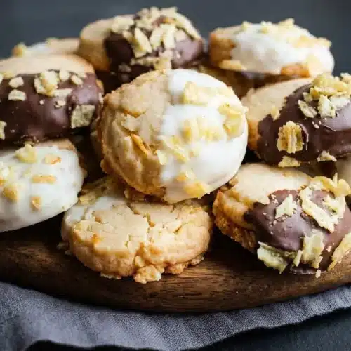 Buttery potato chip cookies with pale ivory tops, golden bottom edges, and crispy chip pieces