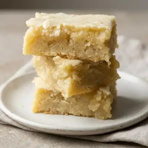 Almond bars recipe baked into chewy squares with golden sliced almonds and powdered sugar