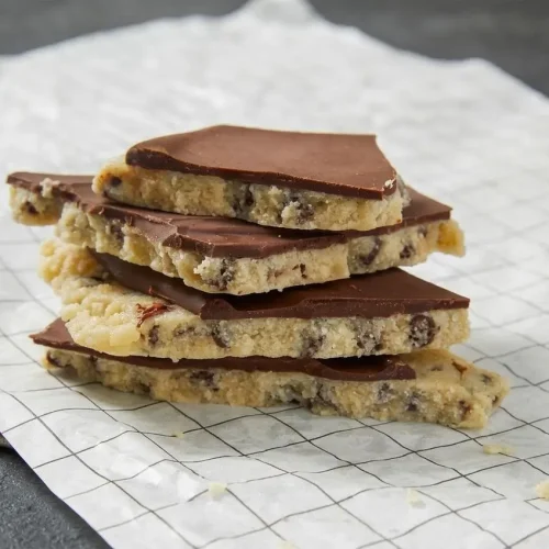 Chilled cookie dough bark broken into pieces with a crisp semisweet chocolate top over almond flour dough.