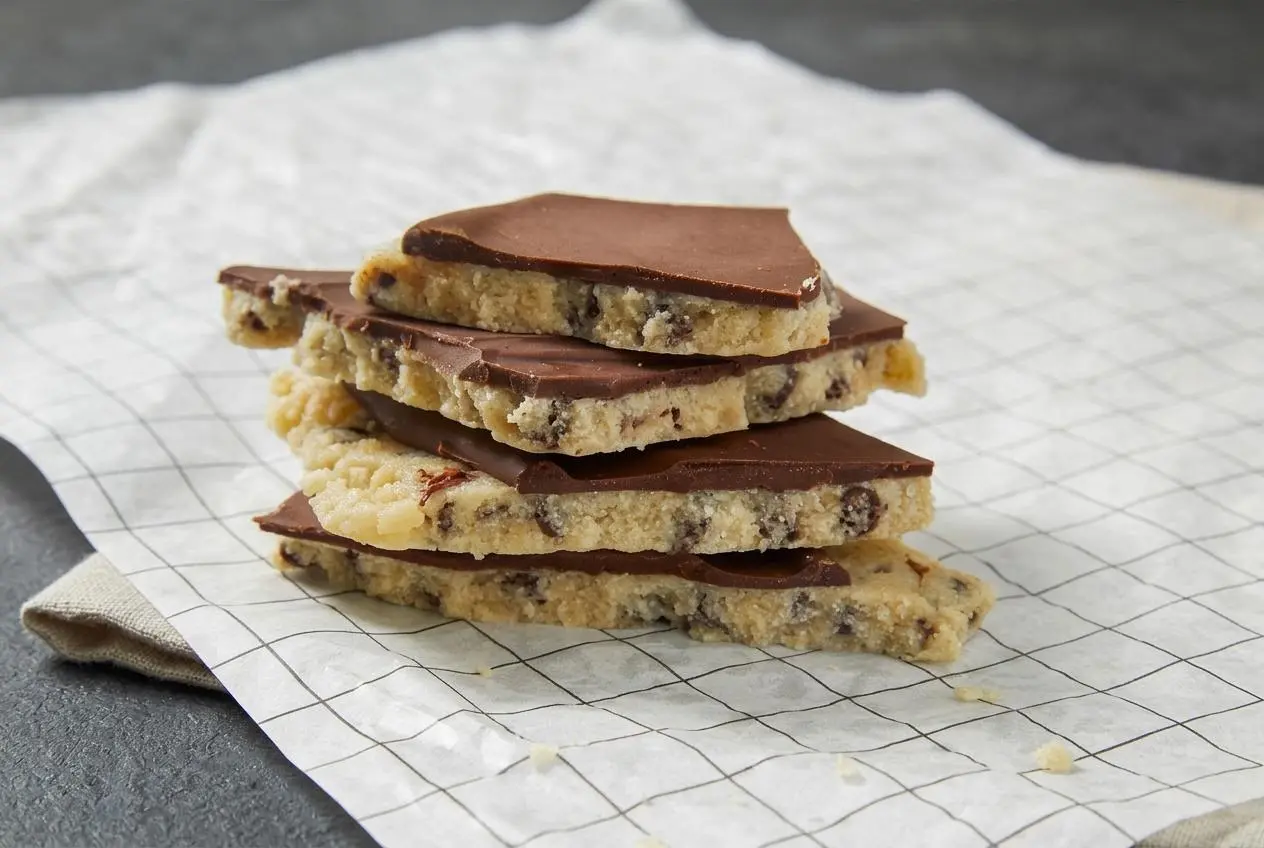 Chilled cookie dough bark broken into pieces with a crisp semisweet chocolate top over almond flour dough.