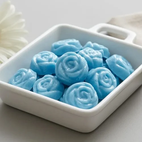 Pastel cream cheese mints with distinct fork-tine ridges and smooth molded shapes on a platter.