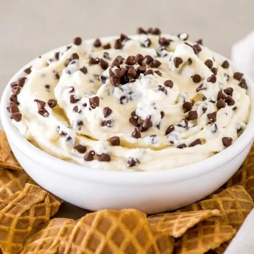 Creamy cannoli dip topped with mini chocolate chips served with crisp broken waffle cones.