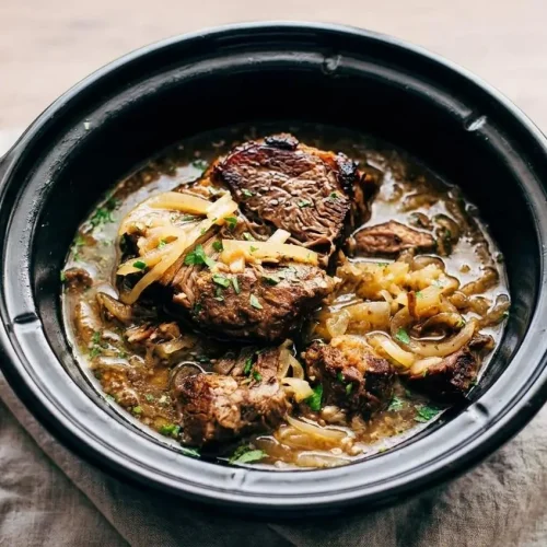 Crock Pot French Onion Pot Roast with fork-tender beef chuck, softened onions, and rich glossy gravy.