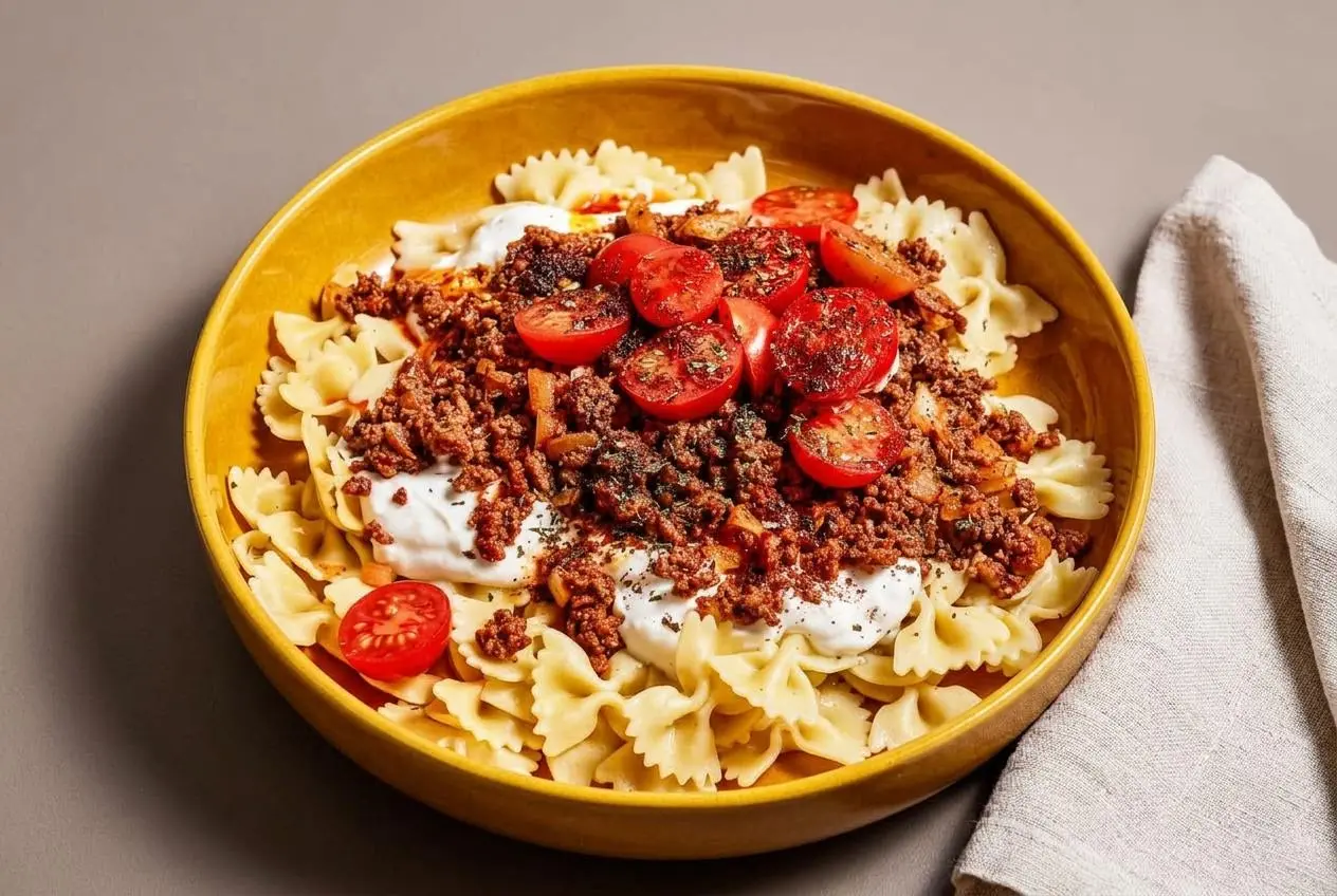 Turkish pasta layered with spiced ground beef, smooth garlic yogurt, and sizzling chili butter on farfalle.