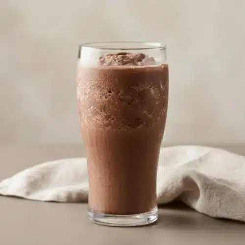 Frozen hot chocolate in a chilled glass with a rich, velvety chocolate slush texture and frosty surface.