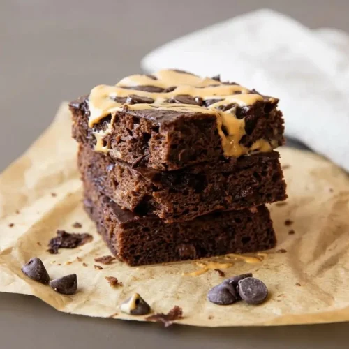 Rich, fudgy cottage cheese brownies cut into squares showing a dense chocolate crumb and melted chocolate chips.