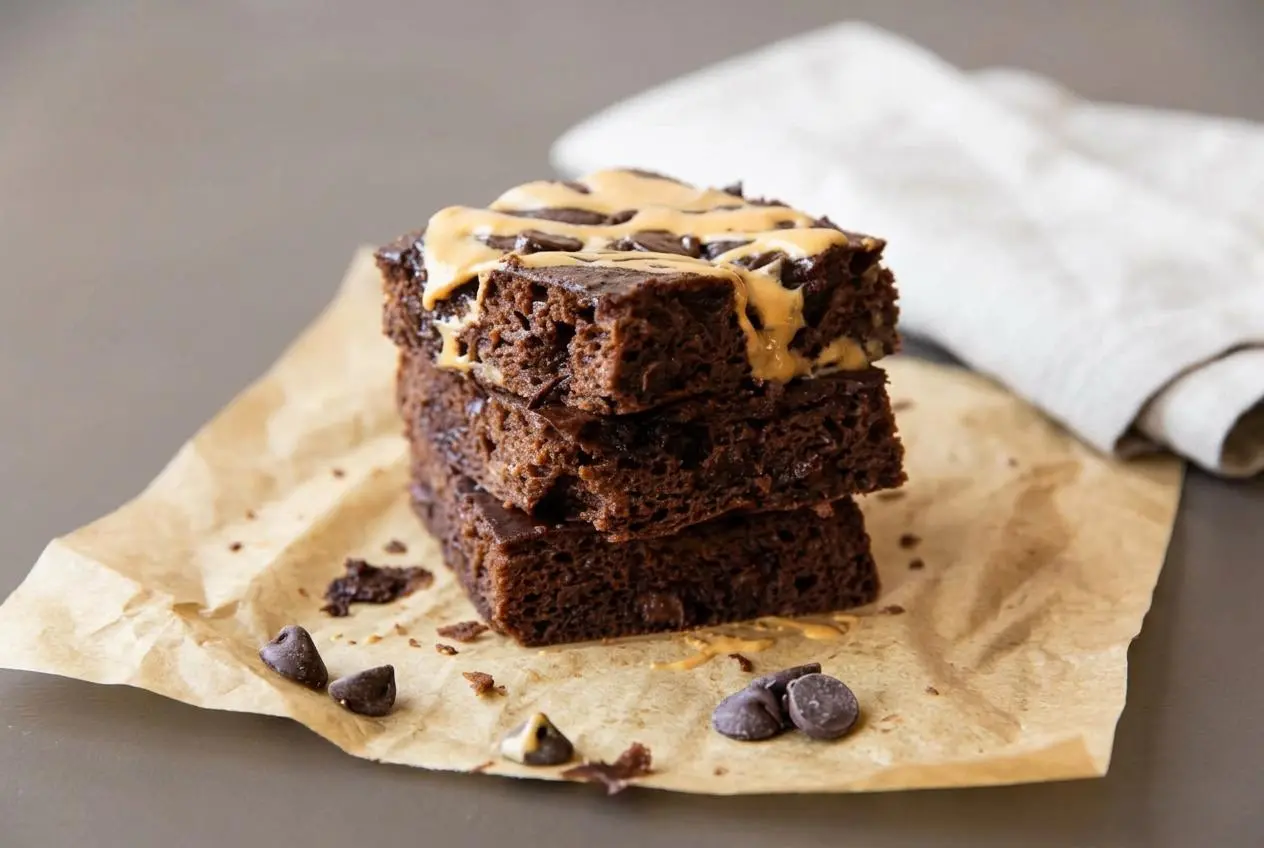 Rich, fudgy cottage cheese brownies cut into squares showing a dense chocolate crumb and melted chocolate chips.