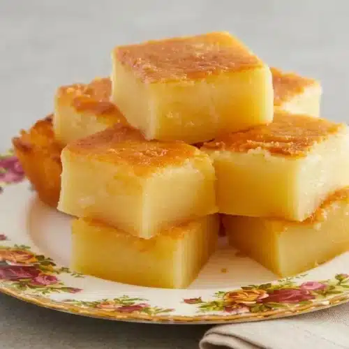 Golden baked Hawaiian butter mochi squares with chewy edges and a glossy coconut custard center.