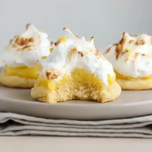 Lemon meringue pie cookies layered with tart citrus curd and toasted meringue peaks.