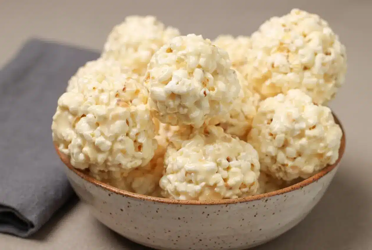 Golden marshmallow popcorn balls with a glossy browned butter coating and crisp salted popcorn clusters