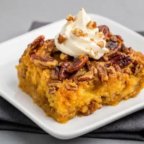 Baked pumpkin crunch cake with a creamy spiced custard base and golden buttery pecan crust