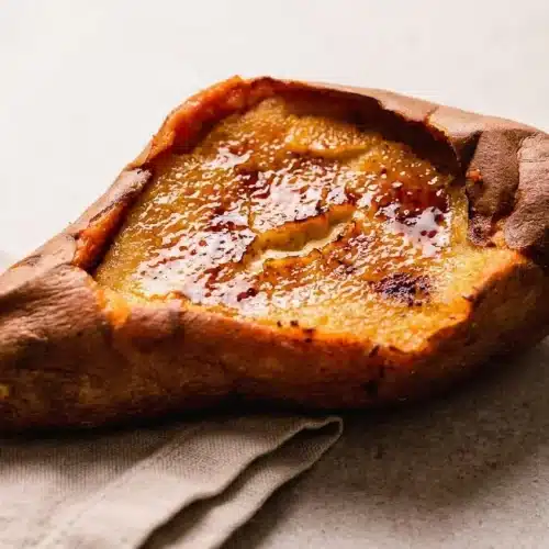 Finished sweet potato creme brulee recipe baked in an edible shell with a glossy caramelized sugar crust