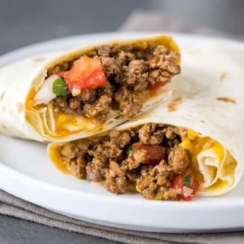 Taco bell meximelt recipe in a soft steamed flour tortilla filled with gooey melted cheese, seasoned beef, and pico de gallo.