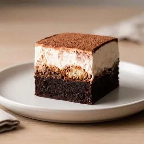 Fudgy tiramisu brownies layered with coffee-soaked ladyfingers and velvety mascarpone cream.