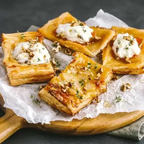 Upside down puff pastry tarts with glossy honey-glazed apricots, pears, melted brie, and golden flaky crust